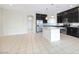 Bright kitchen features a large island, stainless steel appliances, and dark cabinetry in an open-concept design at 8276 Sorrel St, Las Vegas, NV 89139