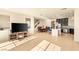 Spacious living area with tiled floors, a kitchen island, stainless appliances, and a dining area at 8276 Sorrel St, Las Vegas, NV 89139