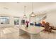 Open-concept living area with tiled floors, a kitchen island, stainless appliances, and dining area at 8276 Sorrel St, Las Vegas, NV 89139