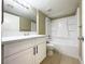 Bathroom showcasing vanity with white cabinets, quartz countertop, and shower-tub combo at 8410 Eldora Ave # 1003, Las Vegas, NV 89117