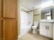 Bathroom including white vanity, shower-tub combo, and wood storage cabinet at 8410 Eldora Ave # 1003, Las Vegas, NV 89117