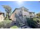 Two story condo featuring staircase, desert landscaping, and neutral colored exterior at 8410 Eldora Ave # 1003, Las Vegas, NV 89117