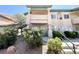 Exterior view of the condo featuring landscaped grounds and stairs to the second level at 8410 Eldora Ave # 1003, Las Vegas, NV 89117