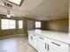Bright kitchen featuring white cabinets, quartz countertop island, and open floor plan at 8410 Eldora Ave # 1003, Las Vegas, NV 89117