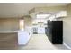 Beautiful kitchen with stainless appliances, modern white cabinetry, and breakfast bar at 8410 Eldora Ave # 1003, Las Vegas, NV 89117