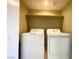 Washer and dryer inside laundry room with shelf above at 8410 Eldora Ave # 1003, Las Vegas, NV 89117