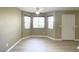 Bright living room featuring a ceiling fan, three windows, and fresh paint at 8410 Eldora Ave # 1003, Las Vegas, NV 89117