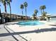 Community pool surrounded by palm trees and desert landscaping at 8410 Eldora Ave # 1003, Las Vegas, NV 89117