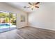 Bright and airy bedroom with sliding door access to the backyard, vinyl floors, and a ceiling fan at 844 Binbrook Dr, Henderson, NV 89052