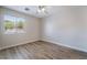 Bright bedroom with hardwood floors and natural light from the large window at 844 Binbrook Dr, Henderson, NV 89052