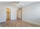 A bedroom featuring neutral walls, wood floors, a ceiling fan and a closet and doorway at 844 Binbrook Dr, Henderson, NV 89052