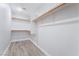 Walk-in closet with shelving and wood-look flooring at 844 Binbrook Dr, Henderson, NV 89052
