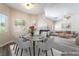 The dining room area features a modern table and seating for six, seamlessly flowing into the living space at 844 Binbrook Dr, Henderson, NV 89052