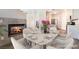 Cozy dining area adjacent to the kitchen featuring a fireplace, table and seating for six at 844 Binbrook Dr, Henderson, NV 89052