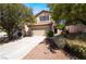 Charming two-story home featuring a well-maintained front yard and an attached two-car garage at 844 Binbrook Dr, Henderson, NV 89052