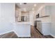 Modern kitchen features sleek white cabinets, stainless steel appliances, and stone countertops at 844 Binbrook Dr, Henderson, NV 89052