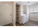 Functional laundry room with modern washer and dryer, shelving, and ample natural light at 844 Binbrook Dr, Henderson, NV 89052