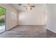 The open floor plan living room boasts ample natural light, wood-look flooring, and outdoor access at 844 Binbrook Dr, Henderson, NV 89052