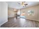 Open-concept living room featuring a tile fireplace, ceiling fan, and sliding glass doors to the outdoor pool area at 844 Binbrook Dr, Henderson, NV 89052