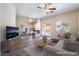 Bright living room with fireplace, ceiling fan, access to the pool and dining area at 844 Binbrook Dr, Henderson, NV 89052