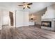 Bright living room features a fireplace that opens to the adjacent dining and kitchen areas at 844 Binbrook Dr, Henderson, NV 89052