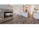 Open-concept living area showcases fireplace, light wood floors, and seamless flow to the kitchen at 844 Binbrook Dr, Henderson, NV 89052