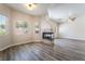 Spacious living room with wood-look floors and a cozy tiled fireplace, perfect for gatherings and relaxation at 844 Binbrook Dr, Henderson, NV 89052