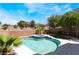Backyard oasis featuring a sparkling pool, spa, and lush landscaping at 844 Binbrook Dr, Henderson, NV 89052