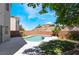 Outdoor pool and spa area, surrounded by a lawn and plants in a fenced-in backyard at 844 Binbrook Dr, Henderson, NV 89052