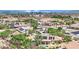 Aerial shot capturing a home featuring a pool and solar panels against the backdrop of the city skyline at 8945 S Tenaya Way, Las Vegas, NV 89113