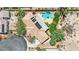 Aerial view of a home featuring a spacious backyard, lush landscaping, a private pool and spa, and mature trees at 8945 S Tenaya Way, Las Vegas, NV 89113