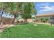 Spacious backyard with lush green lawn, mature landscaping, and a peaceful atmosphere at 8945 S Tenaya Way, Las Vegas, NV 89113