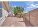 Private backyard featuring desert landscaping, mature trees, and a block wall for added privacy at 8945 S Tenaya Way, Las Vegas, NV 89113
