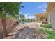 Beautiful backyard with a covered patio, a lush lawn, a sparkling pool and mature landscaping at 8945 S Tenaya Way, Las Vegas, NV 89113