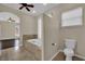 Bright bathroom with a large soaking tub, tiled floors, and natural light from a window at 8945 S Tenaya Way, Las Vegas, NV 89113