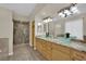 Luxurious bathroom featuring double sinks, granite countertops, and a walk-in shower at 8945 S Tenaya Way, Las Vegas, NV 89113