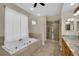 Lavish bathroom featuring a jetted tub, walk-in shower, and modern vanity at 8945 S Tenaya Way, Las Vegas, NV 89113