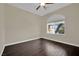 Bright bedroom featuring wood floors, modern ceiling fan, and neutral walls at 8945 S Tenaya Way, Las Vegas, NV 89113