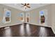 Bright bedroom with hardwood floors, ceiling fan, and patio access at 8945 S Tenaya Way, Las Vegas, NV 89113