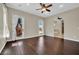 Spacious bedroom with hardwood floors, ceiling fan, and en-suite bathroom access at 8945 S Tenaya Way, Las Vegas, NV 89113