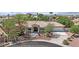Charming single-story home featuring well-manicured landscaping, desert flora, and a circular driveway at 8945 S Tenaya Way, Las Vegas, NV 89113