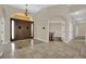 Grand foyer with tile flooring, chandelier, and arched entryway to the dining room at 8945 S Tenaya Way, Las Vegas, NV 89113