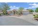 Attractive single-story home with desert landscaping, a circular driveway, and an attached two-car garage at 8945 S Tenaya Way, Las Vegas, NV 89113