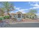 Charming single-story home featuring a landscaped front yard, arched entryway, and a well-manicured garden at 8945 S Tenaya Way, Las Vegas, NV 89113