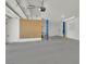 Spacious garage featuring a car lift, ample storage, and a clean, well-lit interior at 8945 S Tenaya Way, Las Vegas, NV 89113
