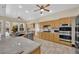 Well-equipped kitchen boasts stainless steel appliances, granite counters, and breakfast bar seating at 8945 S Tenaya Way, Las Vegas, NV 89113
