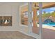 Inviting patio featuring a fireplace, views of outdoor kitchen, and access to the pool area at 8945 S Tenaya Way, Las Vegas, NV 89113