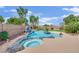 Inviting backyard pool and spa features a rock waterfall, mature landscaping, and desert views at 8945 S Tenaya Way, Las Vegas, NV 89113