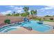 Backyard oasis featuring a custom pool, waterfall feature, tropical plants, and ample space for entertaining at 8945 S Tenaya Way, Las Vegas, NV 89113
