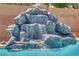 Beautiful pool featuring a natural rock waterfall and crystal-clear water at 8945 S Tenaya Way, Las Vegas, NV 89113